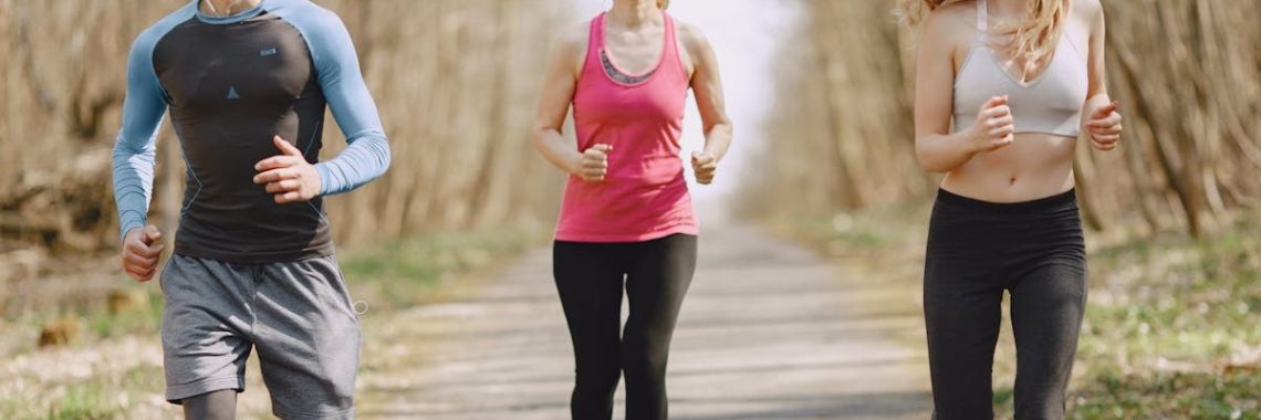 Three adults jogging on a park path, embracing a healthy and active lifestyle.